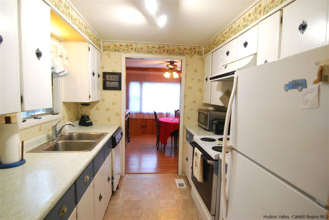 437 Scarawan Road Stone Ridge, NY 12484 - Photo 12 of 35 a kitchen with stainless steel appliances a stove a sink and a refrigerator