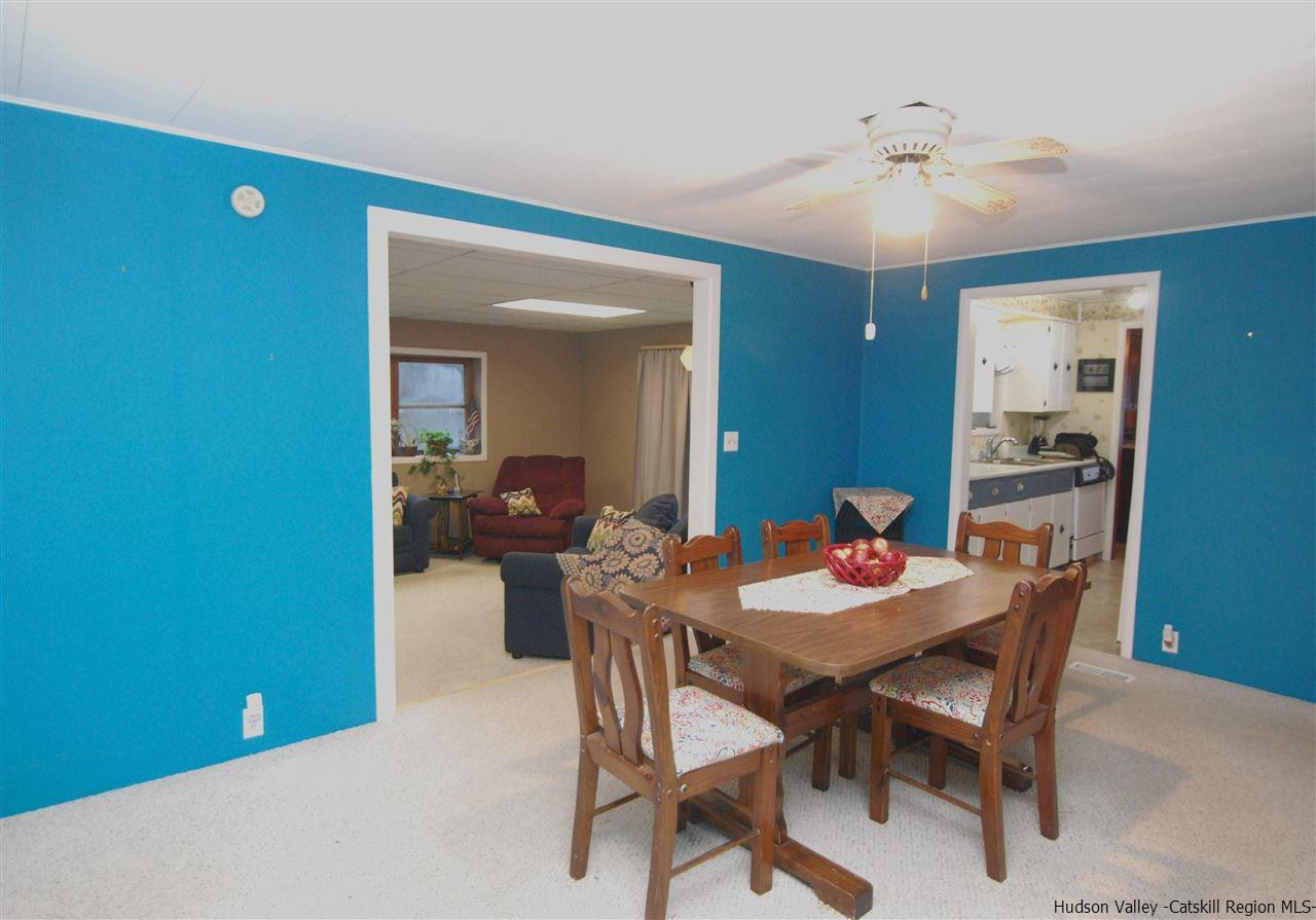 437 Scarawan Road Stone Ridge, NY 12484 - Photo 13 of 35 a view of a dining room with furniture and a chandelier fan