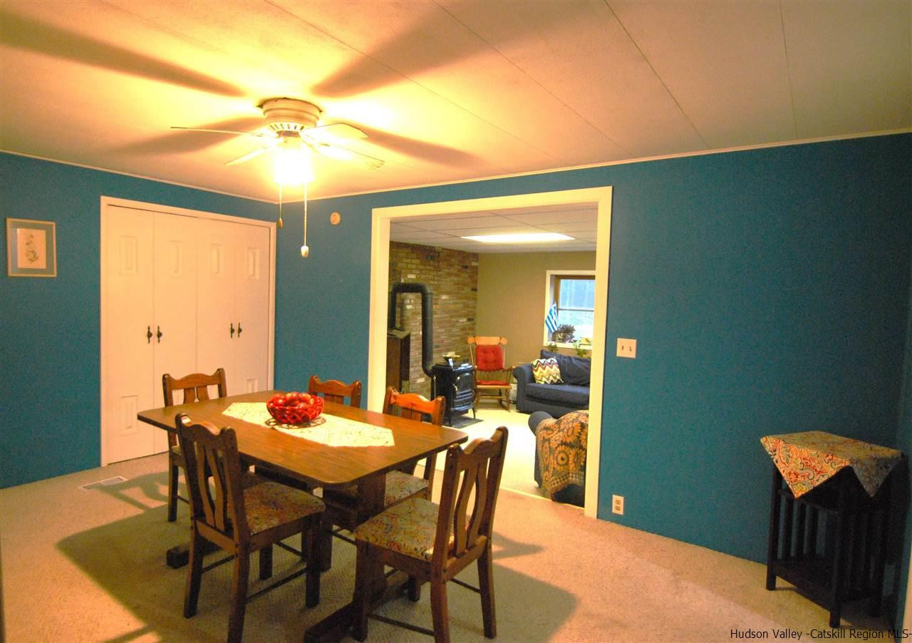 437 Scarawan Road Stone Ridge, NY 12484 - Photo 14 of 35 a view of a dining room with furniture and wooden floor