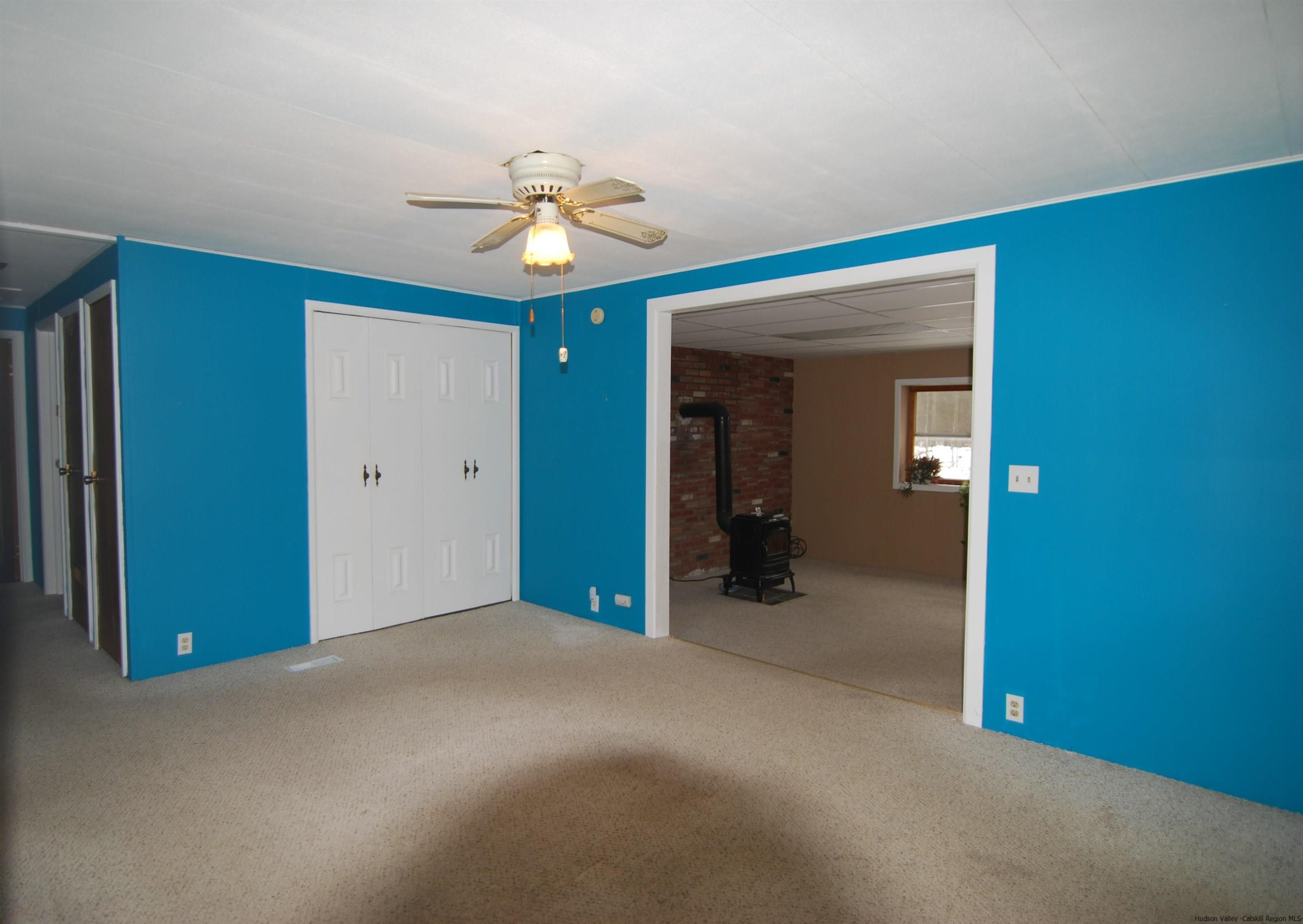 437 Scarawan Road Stone Ridge, NY 12484 - Photo 16 of 35 a view of a livingroom with a chandelier fan and a bathroom