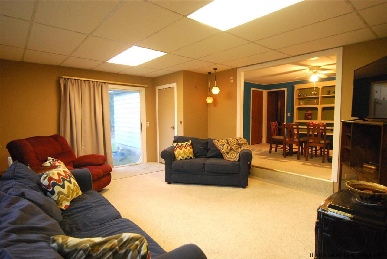 437 Scarawan Road Stone Ridge, NY 12484 - Photo 17 of 35 a living room with furniture and a flat screen tv