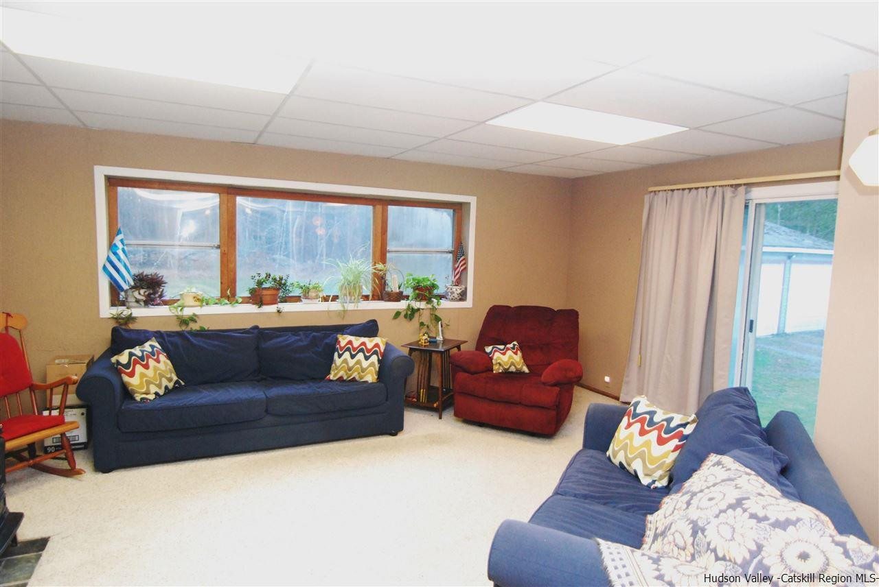 437 Scarawan Road Stone Ridge, NY 12484 - Photo 19 of 35 a living room with furniture and a large window