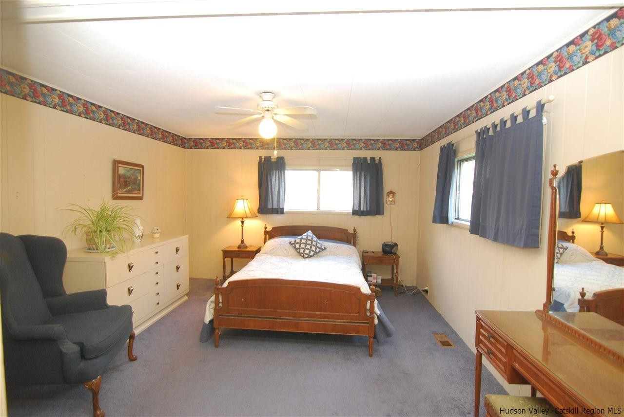 437 Scarawan Road Stone Ridge, NY 12484 - Photo 23 of 35 a bedroom with furniture and a large window