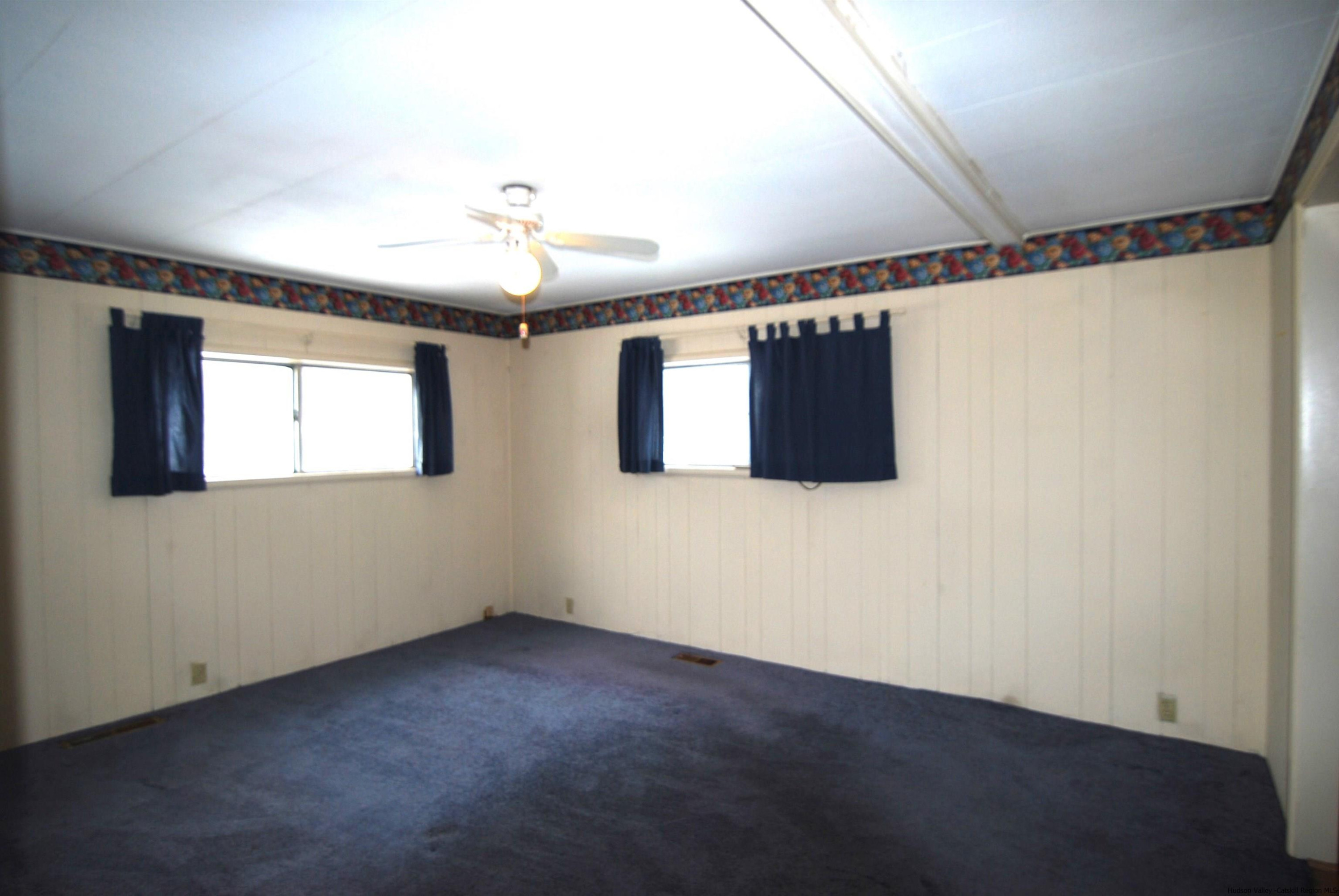 437 Scarawan Road Stone Ridge, NY 12484 - Photo 24 of 35 a view of a livingroom with a ceiling fan and window