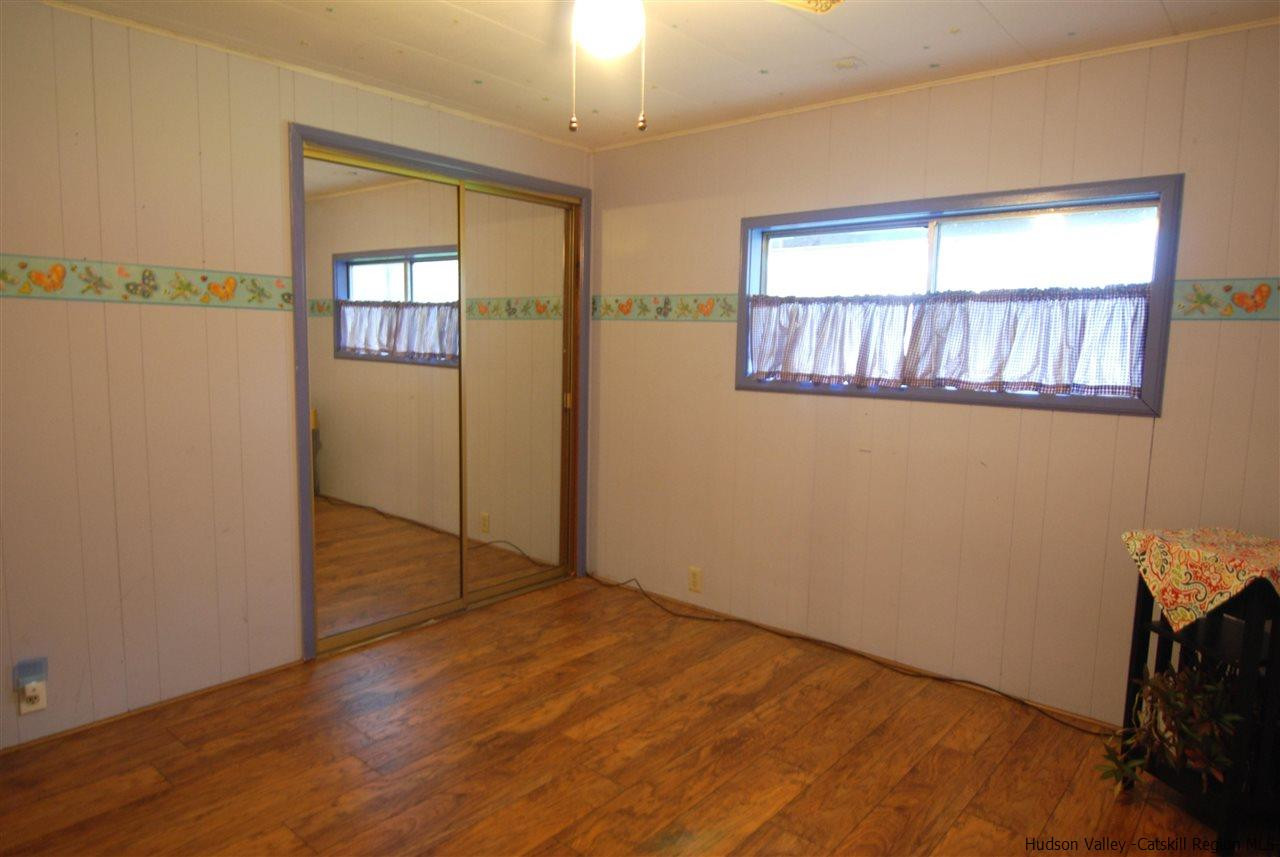 437 Scarawan Road Stone Ridge, NY 12484 - Photo 29 of 35 a view of empty room with wooden floor and fan