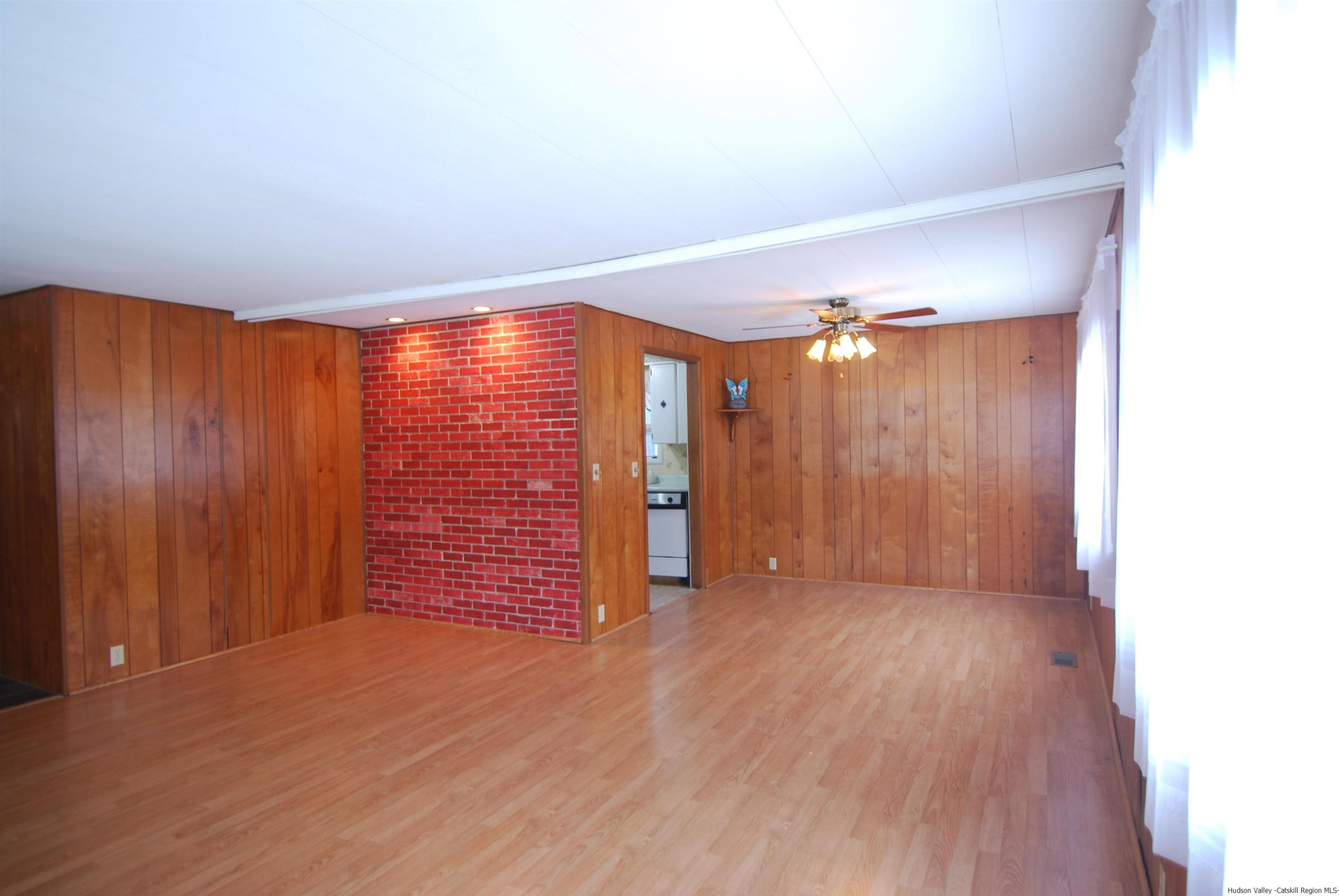437 Scarawan Road Stone Ridge, NY 12484 - Photo 8 of 35 a view of an empty room with wooden floor and a window