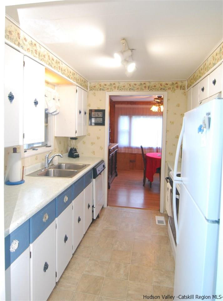 437 Scarawan Road Stone Ridge, NY 12484 - Photo 9 of 35 a large white kitchen with a large window