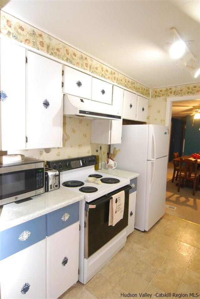 437 Scarawan Road Stone Ridge, NY 12484 - Photo 10 of 35 a kitchen with stainless steel appliances granite countertop a stove a sink and a refrigerator