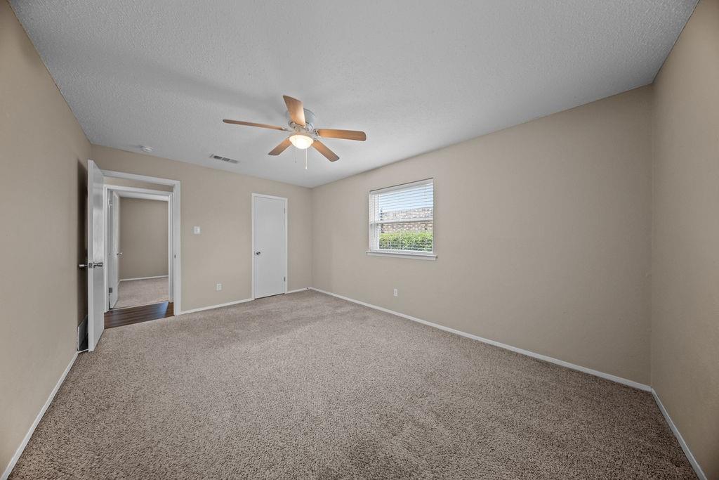 1041 Barber Street Hurst, TX 76053 - Photo 19 of 36 an empty room with a window and a fan