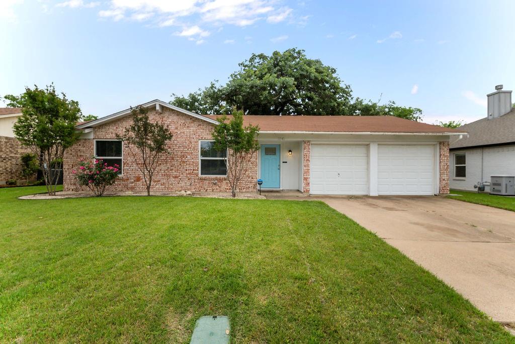 1041 Barber Street Hurst, TX 76053 - Photo 2 of 36 a front view of house with yard and outdoor seating