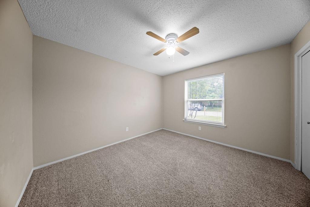 1041 Barber Street Hurst, TX 76053 - Photo 23 of 36 an empty room with windows and fan