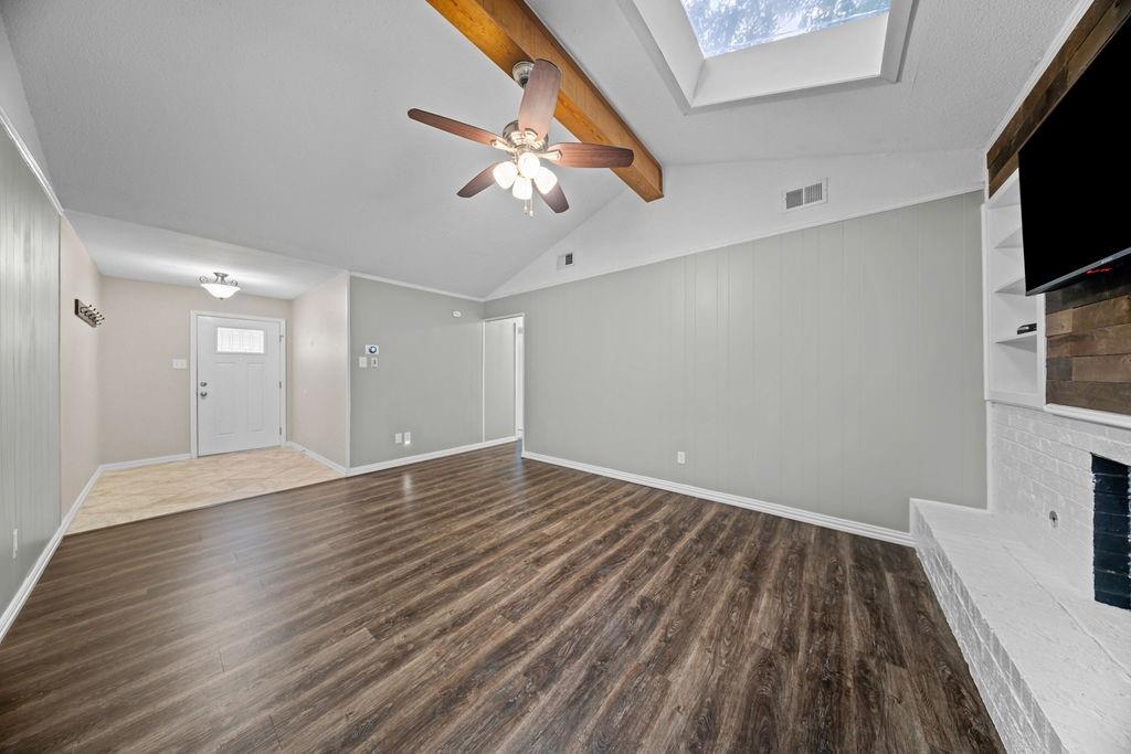 1041 Barber Street Hurst, TX 76053 - Photo 5 of 36 wooden floor in an empty room with a window