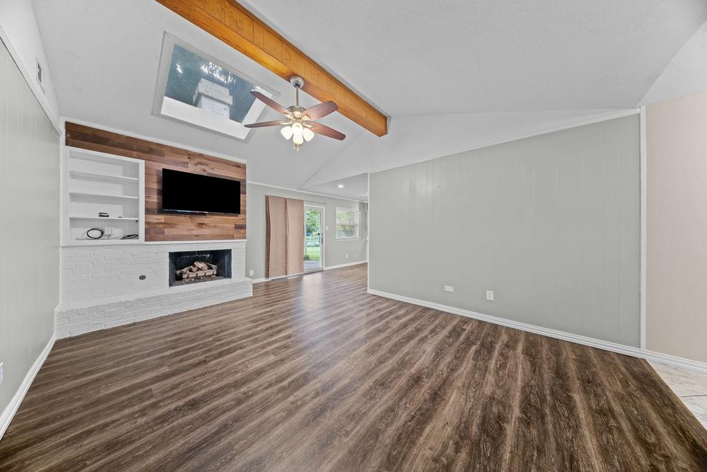 1041 Barber Street Hurst, TX 76053 - Photo 9 of 36 a view of empty room with fireplace and wooden floor