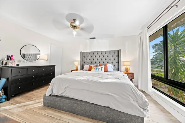 a bedroom with a large bed and a window