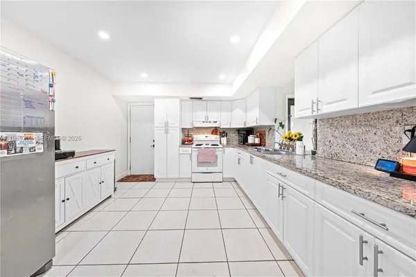 a kitchen with stainless steel appliances granite countertop a sink and cabinets