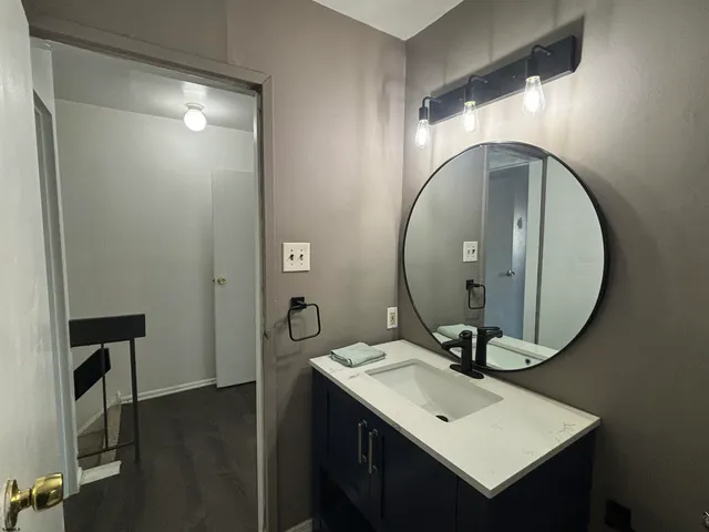 a bathroom with a sink mirror and vanity