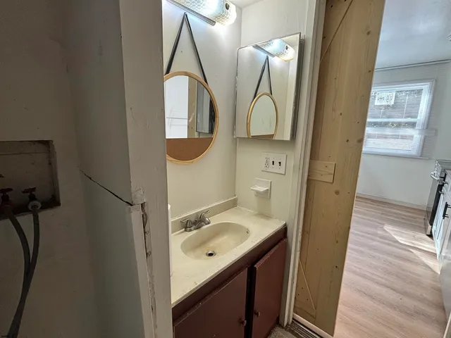 a bathroom with a sink a mirror and vanity