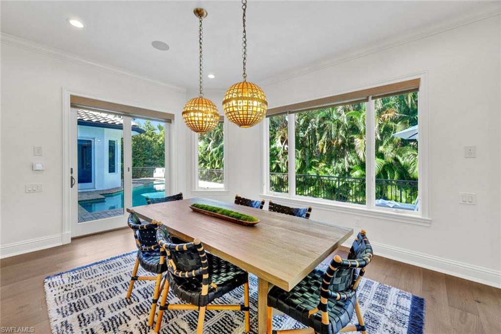 445 Putter Point Drive Naples, FL 34103 - Photo 13 of 44 a dining room view with a table and chairs