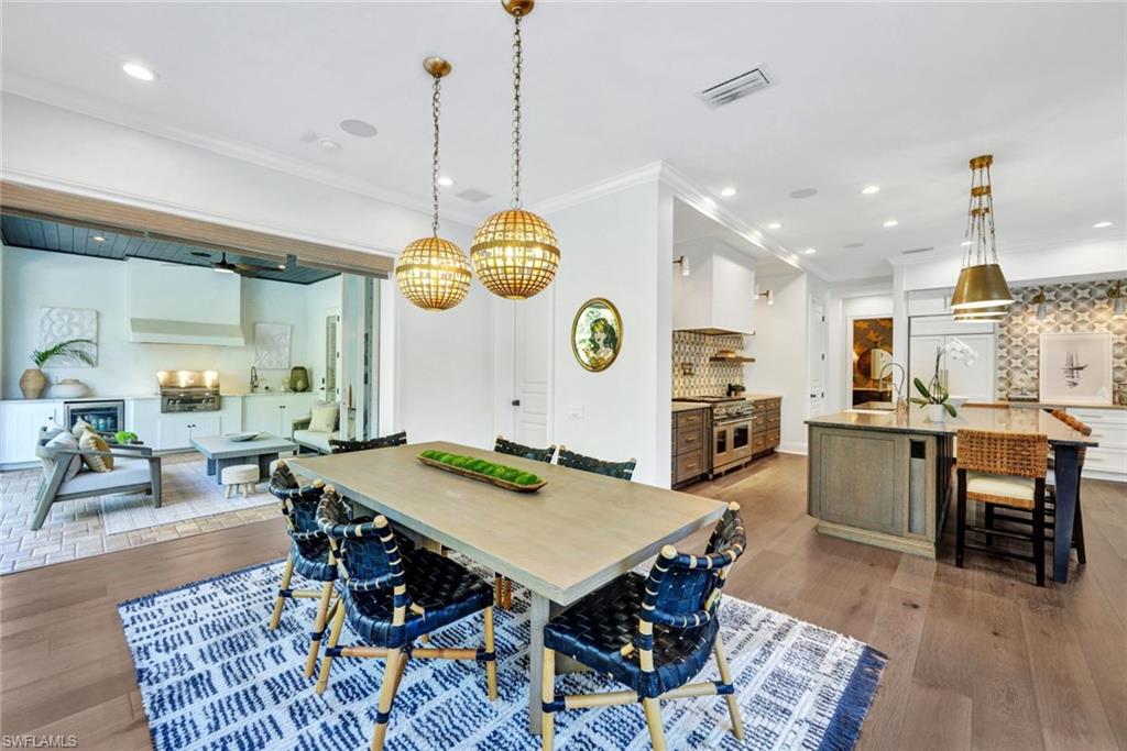445 Putter Point Drive Naples, FL 34103 - Photo 14 of 44 a view of a dining area with furniture