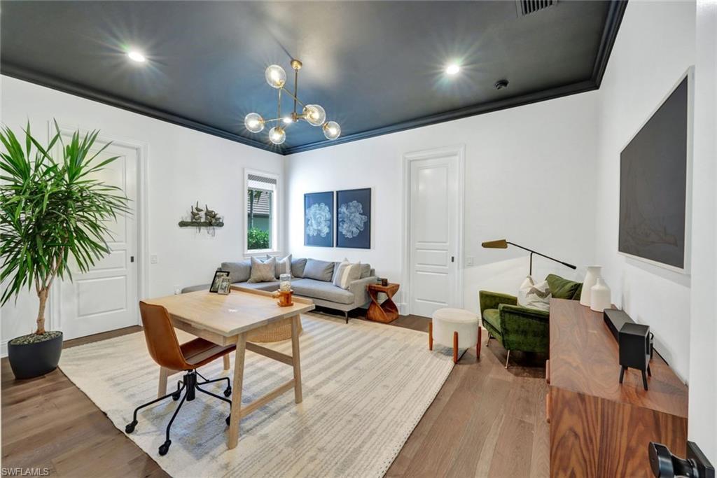 445 Putter Point Drive Naples, FL 34103 - Photo 15 of 44 a living room with furniture and a flat screen tv
