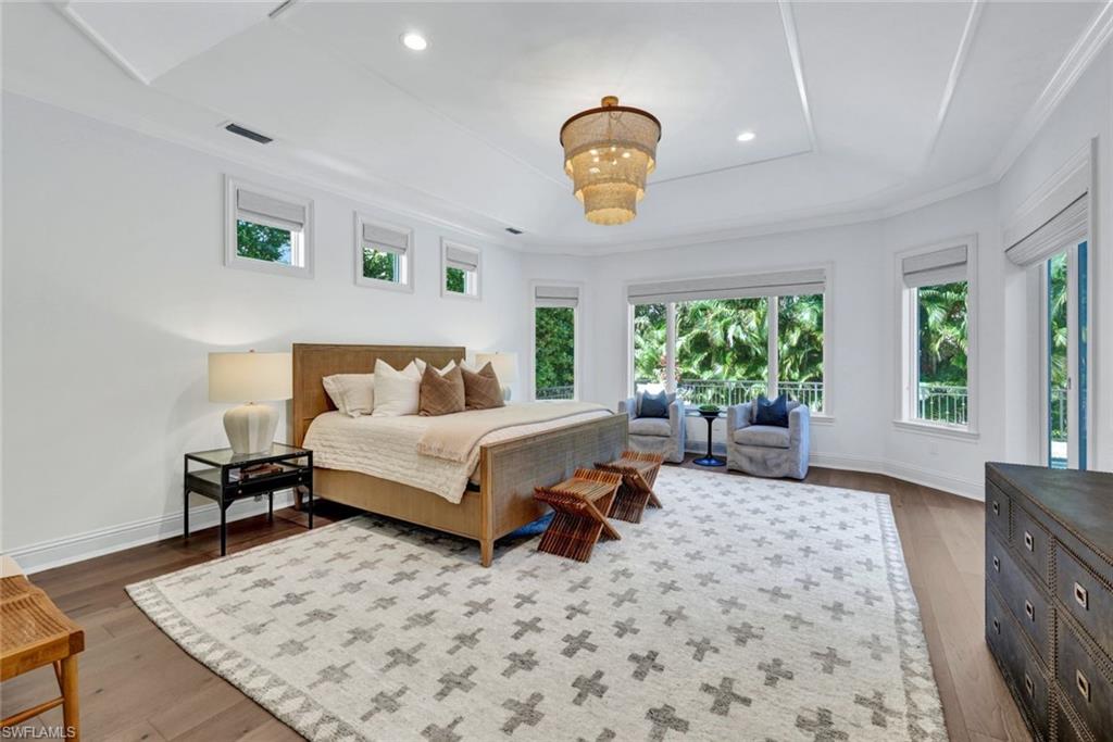 445 Putter Point Drive Naples, FL 34103 - Photo 19 of 44 a bedroom with a bed and window