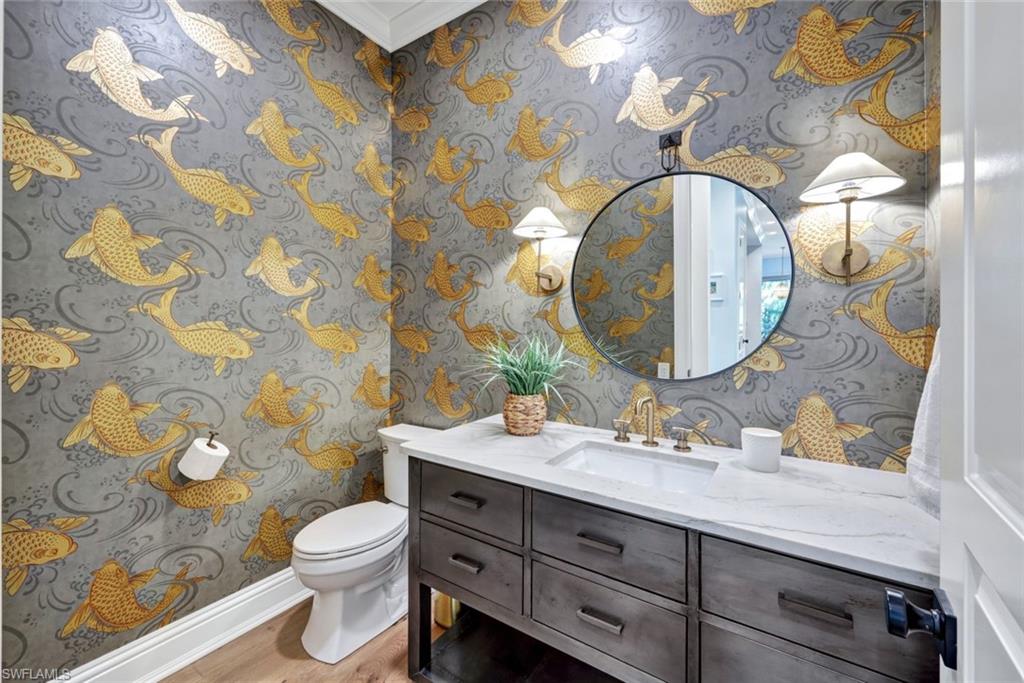 445 Putter Point Drive Naples, FL 34103 - Photo 26 of 44 a bathroom with a sink mirror vanity and toilet