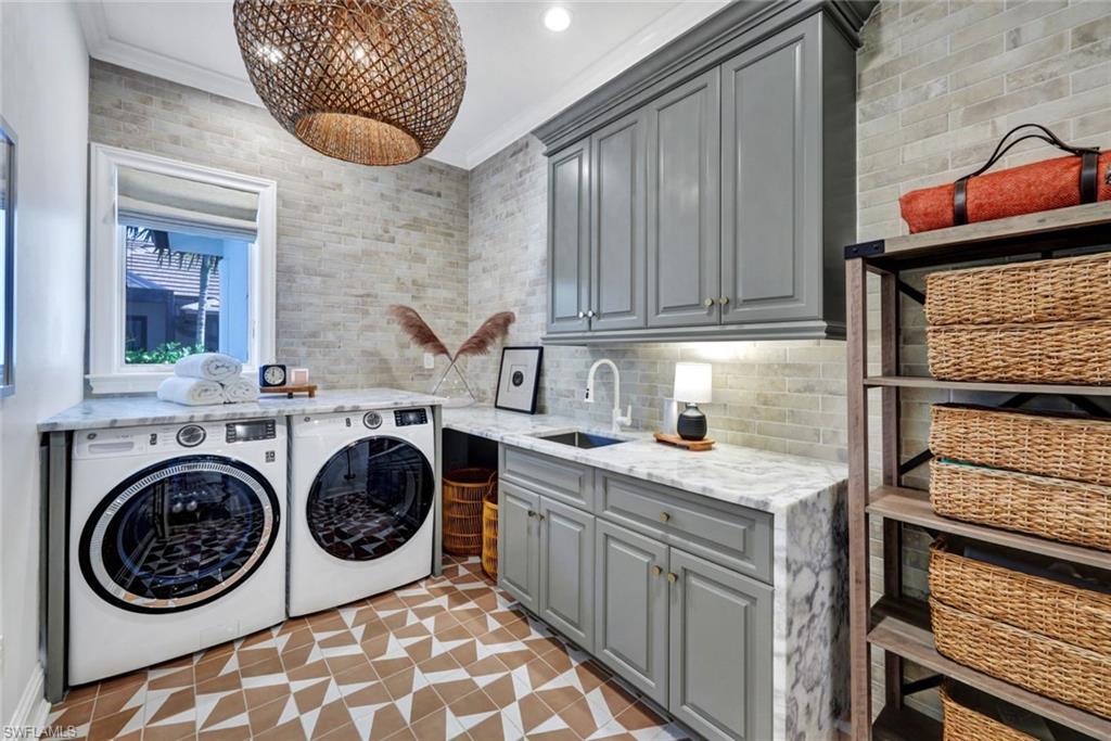 445 Putter Point Drive Naples, FL 34103 - Photo 27 of 44 a utility room with dryer and washer