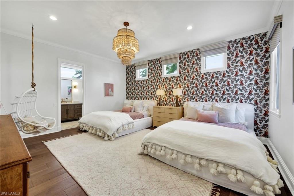 445 Putter Point Drive Naples, FL 34103 - Photo 34 of 44 a bedroom with bed and wooden floor