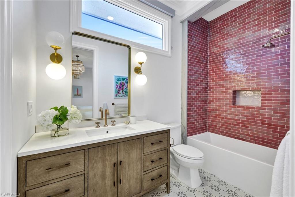 445 Putter Point Drive Naples, FL 34103 - Photo 35 of 44 a bathroom with a sink a toilet and shower