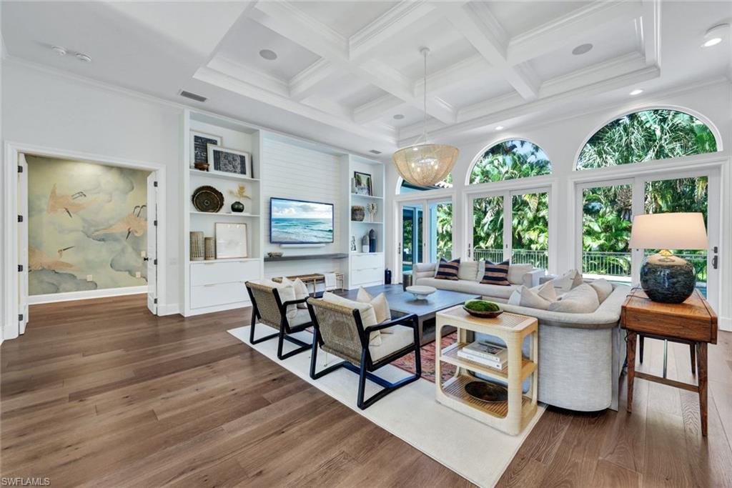 445 Putter Point Drive Naples, FL 34103 - Photo 4 of 44 a very nice looking living room with a large window and dining table