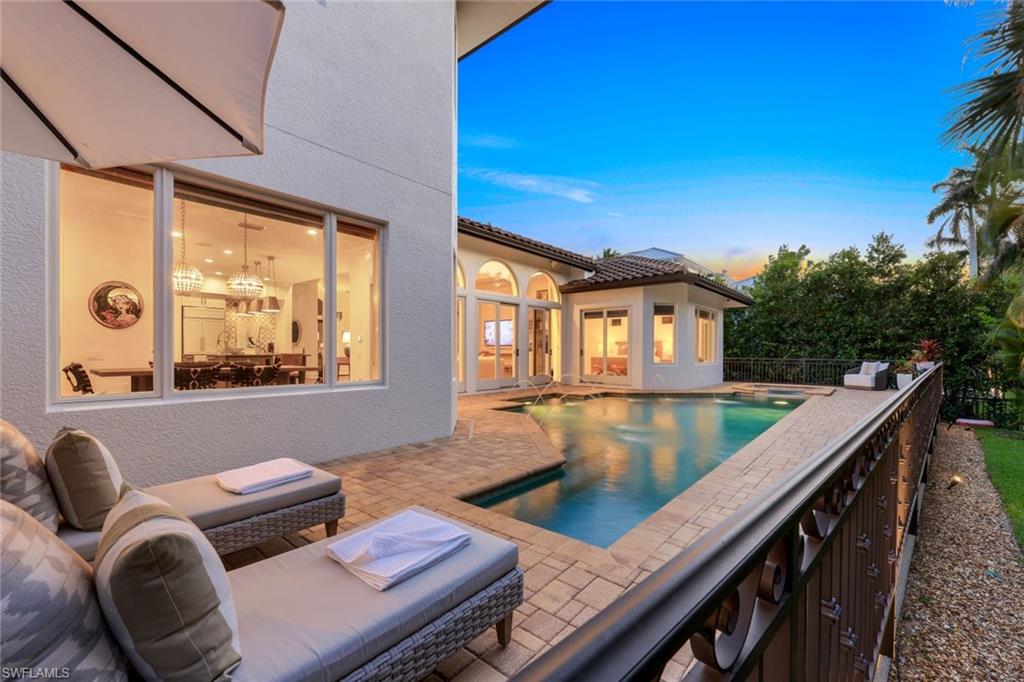 445 Putter Point Drive Naples, FL 34103 - Photo 41 of 44 a balcony with table and chairs