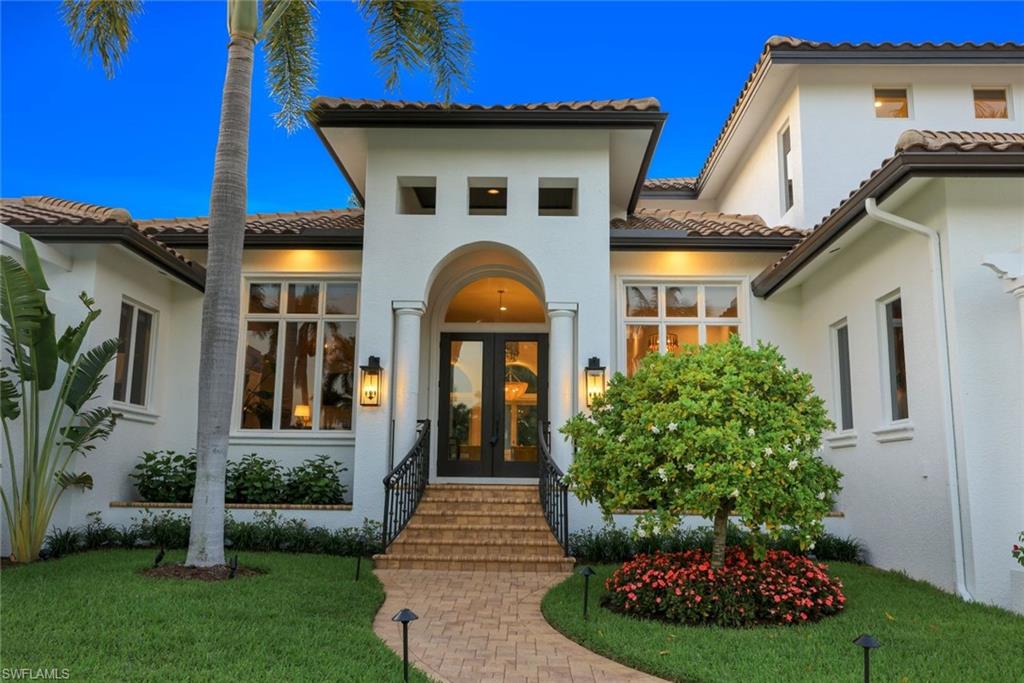445 Putter Point Drive Naples, FL 34103 - Photo 43 of 44 a front view of a house with garden
