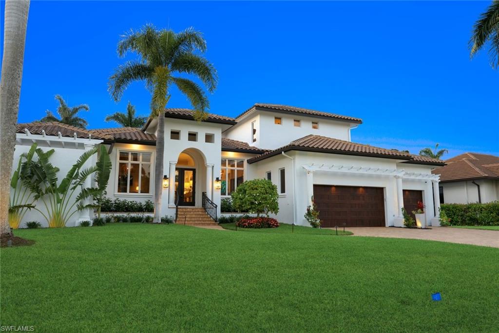 445 Putter Point Drive Naples, FL 34103 - Photo 44 of 44 a front view of a house with garden
