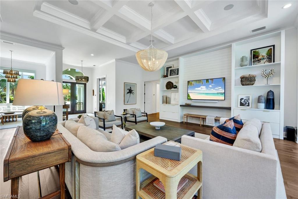 445 Putter Point Drive Naples, FL 34103 - Photo 5 of 44 a living room with furniture and wooden floor
