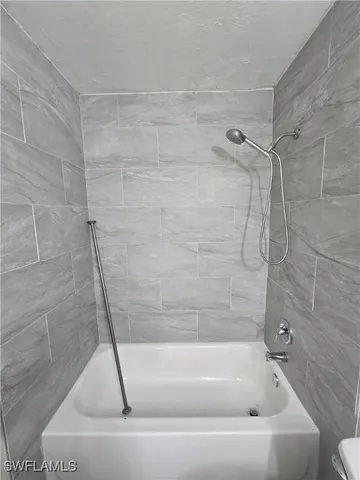 a bathroom with a bath tub and a shower