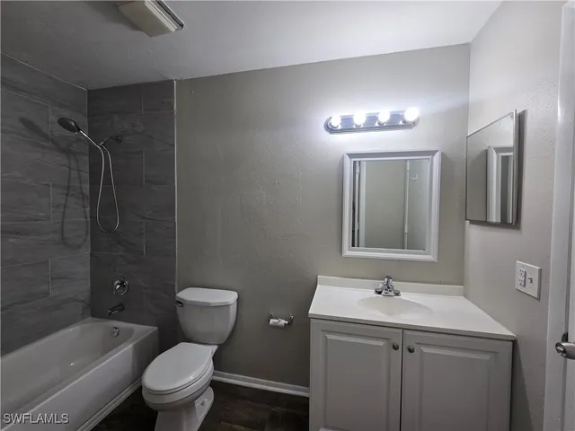 a bathroom with a toilet sink shower and mirror