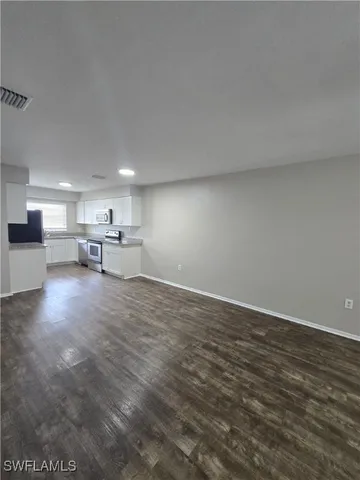 a view of kitchen with furniture and wooden floor