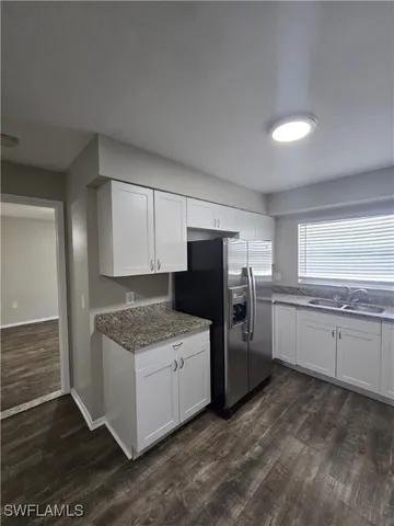 a kitchen with a sink stove and refrigerator