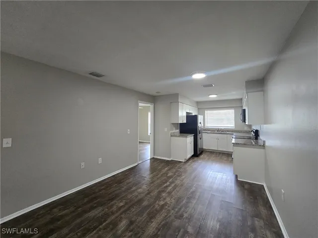 a view of a kitchen with wooden floor