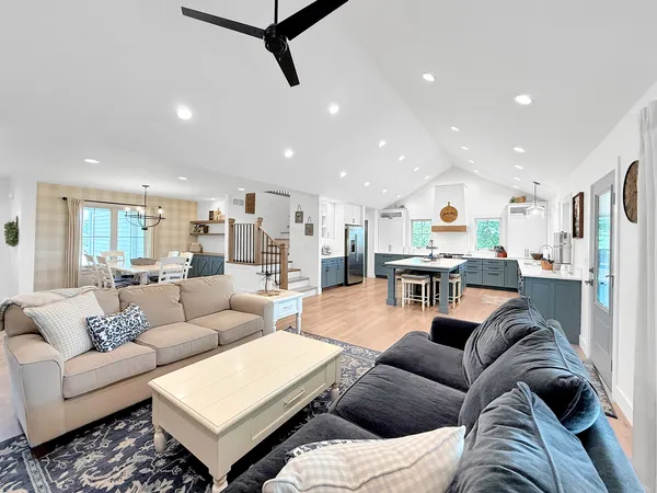 a living room with furniture fireplace and kitchen view