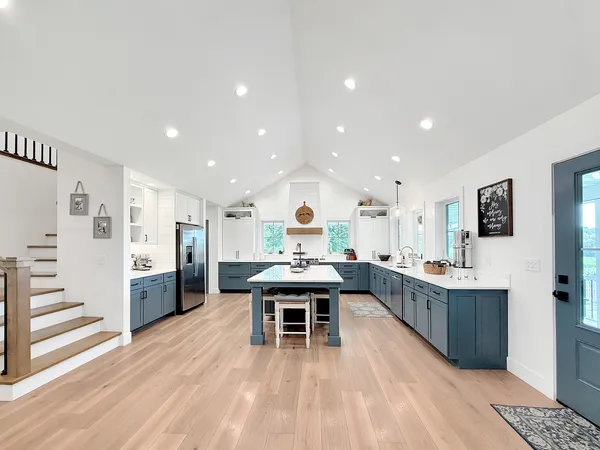 a large bedroom with a large bed and a potted plant