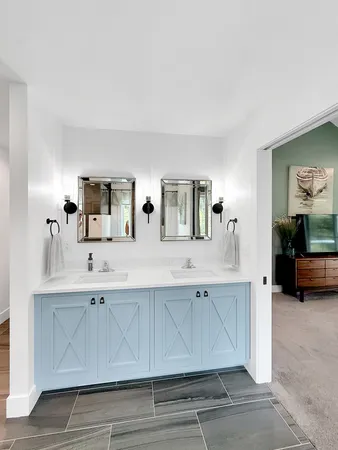 a bathroom with a double vanity sink a mirror and a bathtub