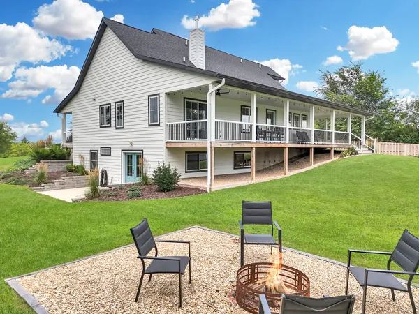a view of a house with backyard sitting area and garden