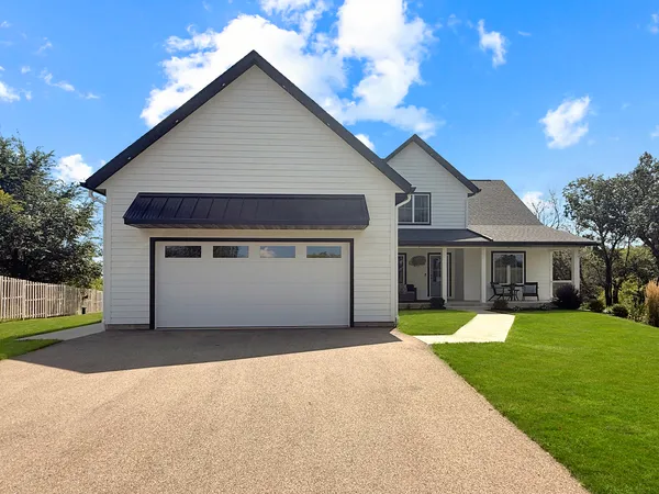 a front view of a house with a yard and garage