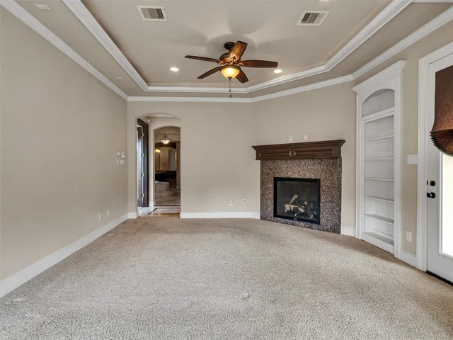 a view of an empty room with a fireplace