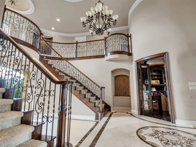 a view of entryway and hall with a chandelier