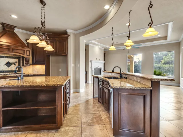 a kitchen with a stove and a chandelier