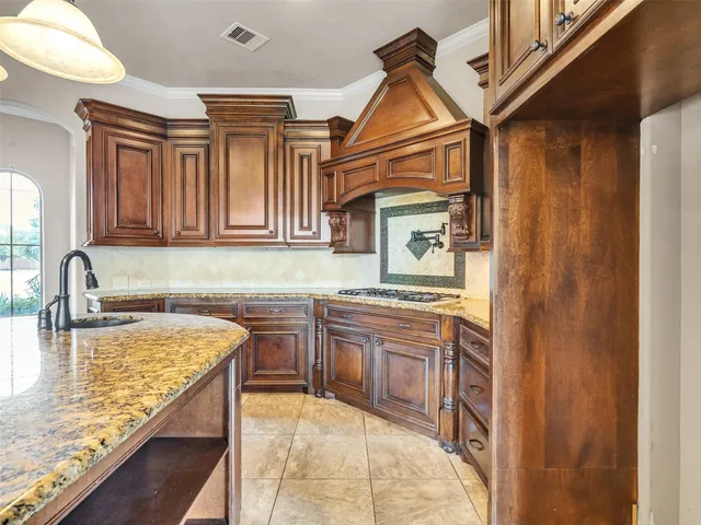 a kitchen with stainless steel appliances granite countertop a sink and cabinets
