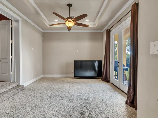an empty room with fan front door and fan