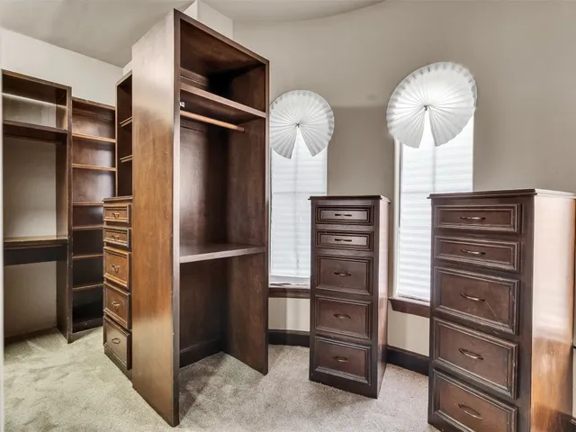 a view of walk in closet with empty racks